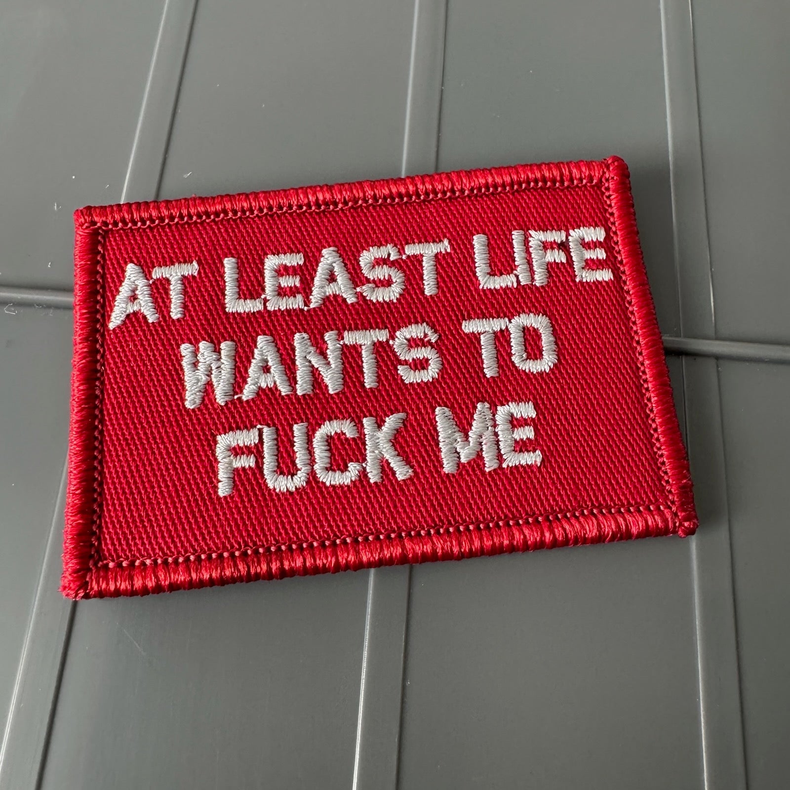 As Seen on Socials - At Least Life Wants To Fuck Me - Red w/Silver - 2x3