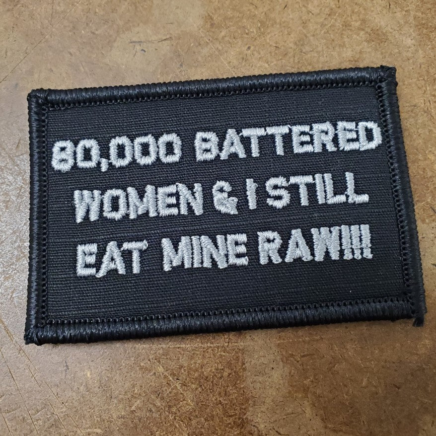 As Seen on Socials - 80,000 Battered Women & I Still Eat Mine Raw!!! - 2x3 Patch - Black w/Silver